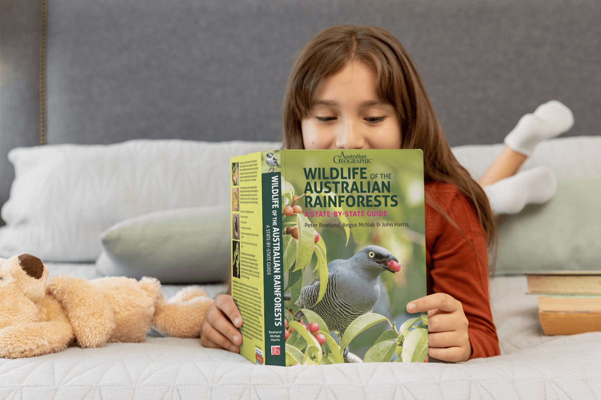Girl Reading Rainforests Book A Girl lying on her bed reading the Wildlife of the Australia's Rainforests book